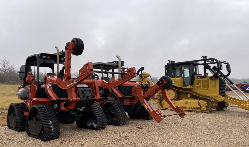 Ditch Witch RT125 utility tractor equipped with a tracked plow for underground installation