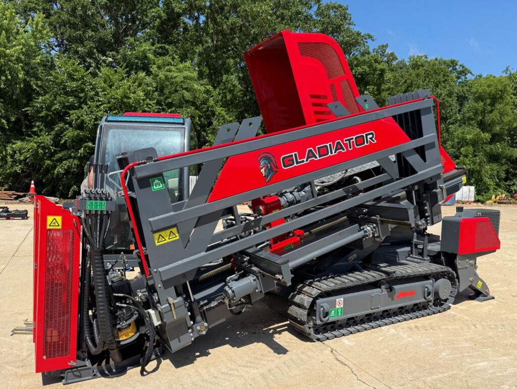 Close-up of a Gladiator horizontal directional drill rod rack and tracked drilling system