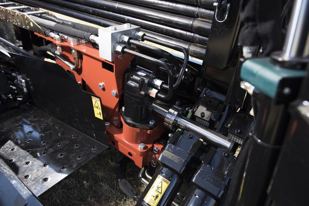Ditch Witch JT10 drill rod rack and hydraulic assembly shown in detailed close-up