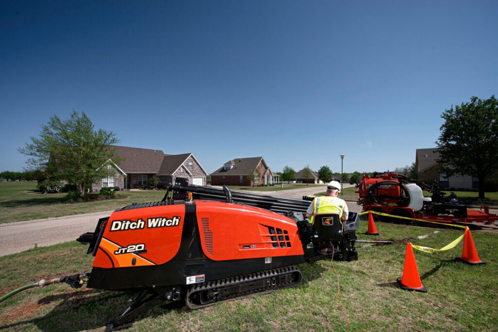 Ditch Witch JT20 directional drill operating at a residential underground utility worksite