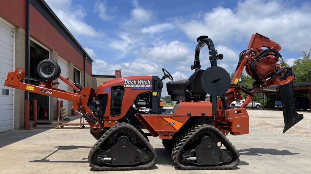 Side view of Ditch Witch RT70 Quad plow equipment configured for trenching and underground utility work