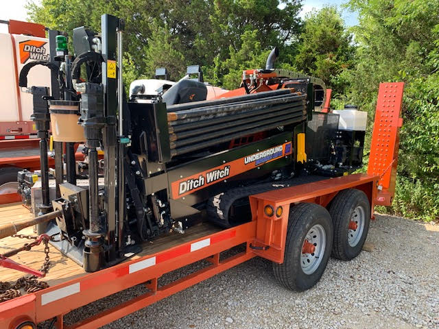 Ditch Witch JT10 drill rod rack and hydraulic assembly shown in detailed close-up