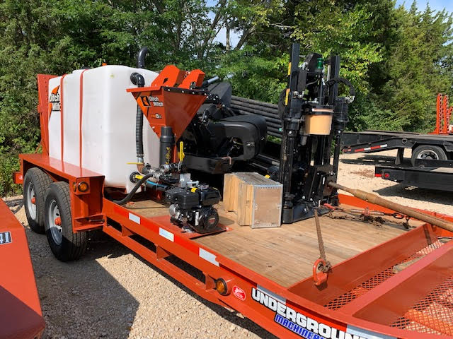 Side view of the Ditch Witch JT10 drill carriage, rod rack, and tracked machine frame