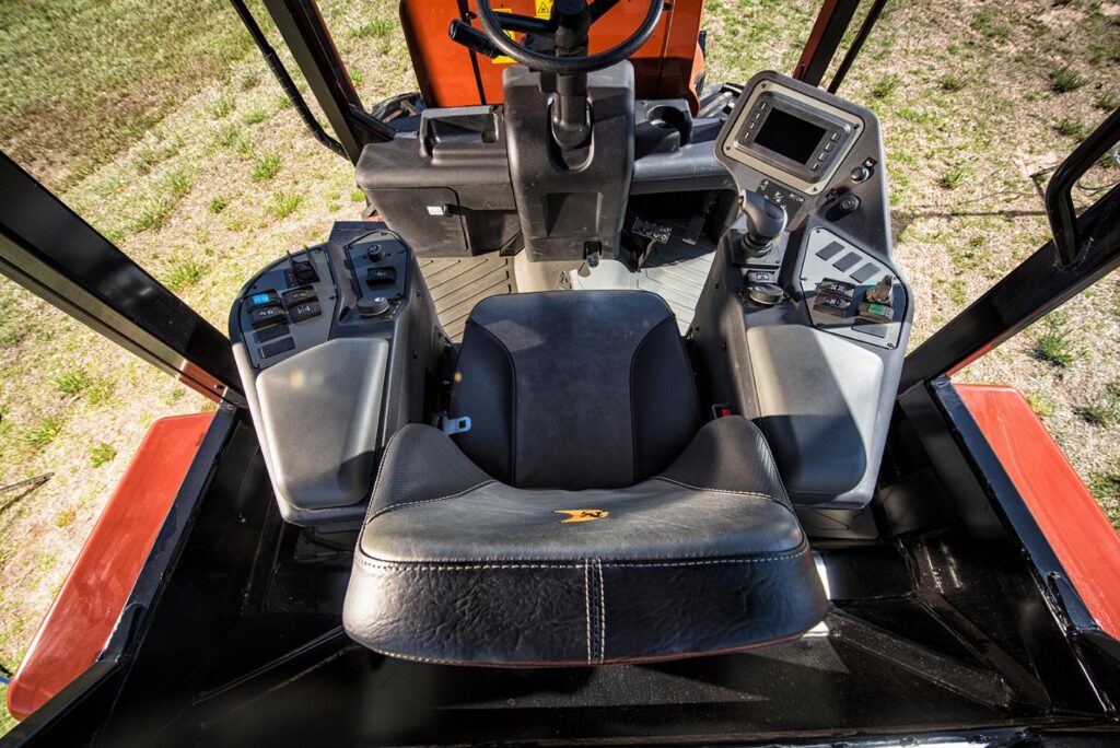 Operator seat and control area inside a Ditch Witch RT125 utility tractor